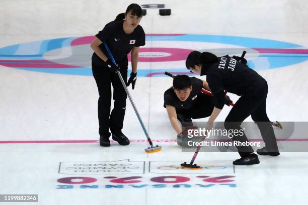 Asei Nakahara of Japan plays a rock with Momoha Tabata and Mina Kobayashi in their Mixed Team Finals Gold Medal match in curling against Norway...