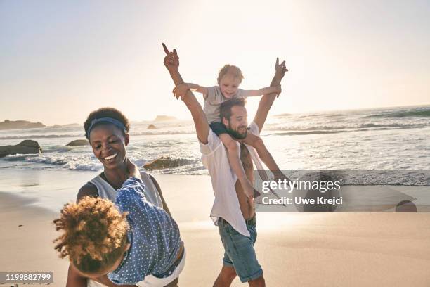 family playing on beach - female hairy chest stock-fotos und bilder