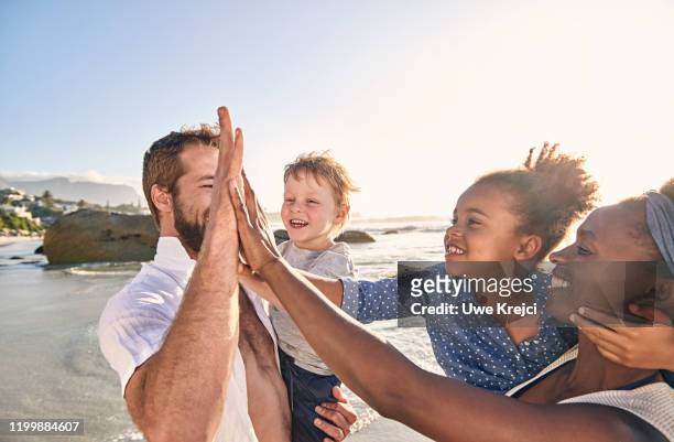 family playing on beach - female hairy chest stock-fotos und bilder