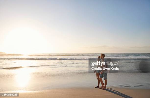 young couple on beach - female hairy chest stock-fotos und bilder