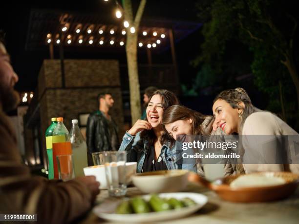 group of friends partying outdoor at night - mexican food party stock pictures, royalty-free photos & images