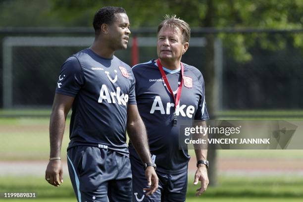 Dutch FC Twente football club coach Co Adriaanse speaks with Patrick Kluivert during his first training session with his team in Hengelo on June 28,...