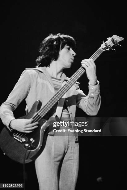 British bass guitarist Bill Wyman as The Rolling Stones play the Knebworth Fair in the grounds of Knebworth House in Knebworth, Hertfordshire,...