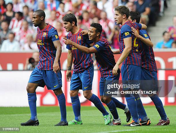 Barcelona's Thiago Alcantara celebrates with teammates after scoring the 1-0 goal during their Audi Cup football match FC Barcelona vs SC...