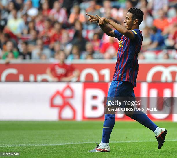 Barcelona's Thiago Alcantara celebrates after scoring the 1-0 goal during their Audi Cup football match FC Barcelona vs SC International de Porto...