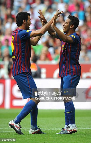 Barcelona's Thiago Alcantara and his teammate Sergio celebrate after the first goal for their team during their Audi Cup football match FC Barcelona...