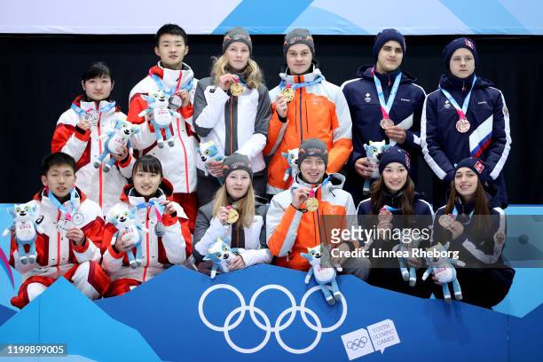Gold Medalist Team Norway , Silver Medalist Team Japan and Bronze medalist team of Russia pose for a photo during the medal ceremony for the Mixed...