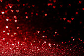 valentines day background with red hearts glitter bokeh on black, card for Valentine's day, christmas and wedding celebration, Love bokeh shiny confetti textured template