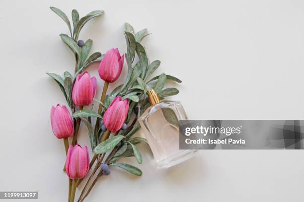 pink tulips bouquet and perfume bottle - ranunculus wedding bouquet stock pictures, royalty-free photos & images