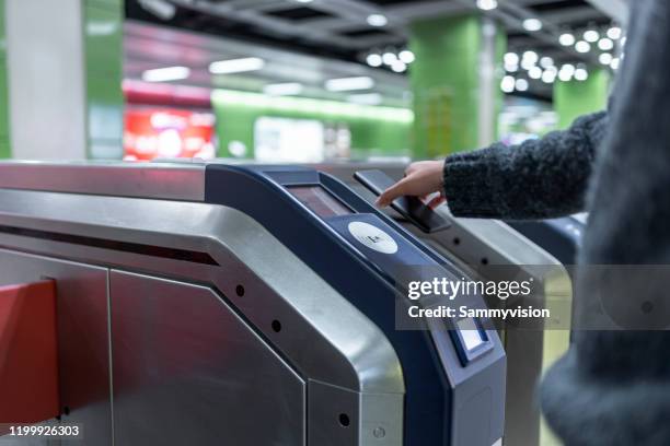 contactless payment for entering metro station - entering turnstile stock pictures, royalty-free photos & images