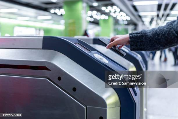 contactless payment for entering metro station - entering turnstile stock pictures, royalty-free photos & images