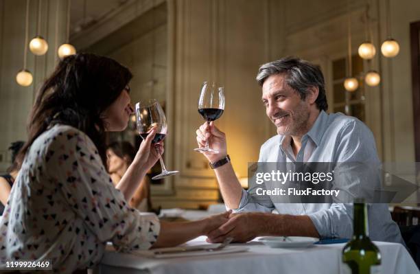beautiful couple in love celebrating anniversary on valentine's day - table for two stock pictures, royalty-free photos & images