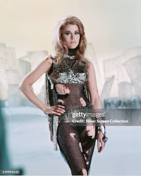 Jane Fonda, US actress, in costume, with spots of blood on her arms, torso and leg, in a publicity portrait issued for the film, 'Barbarella', 1968....