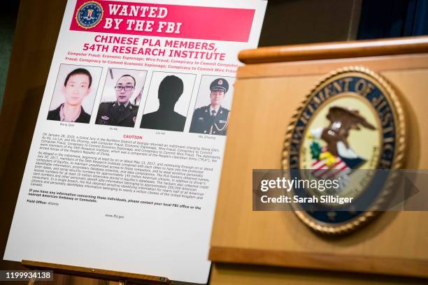 Signs that depict the four members of China's military indicted on charges of hacking into Equifax Inc. And stealing data from millions of Americans...