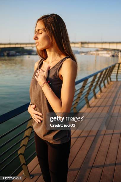 beautiful woman with closed eyes practicing yoga breathing - pranayama stock pictures, royalty-free photos & images