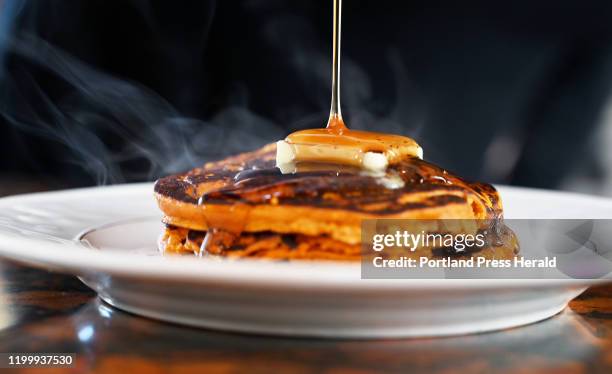 Christine Burn Rudalevige puts maple syrup on her sweet potato pancakes Wednesday, Jan. 29, 2019.