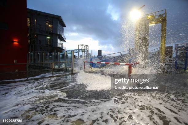 February 2020, Schleswig-Holstein, Dagebüll: Spray splashes onto the pier of the ferry pier in Dagebüll. In the afternoon there was a storm surge on...