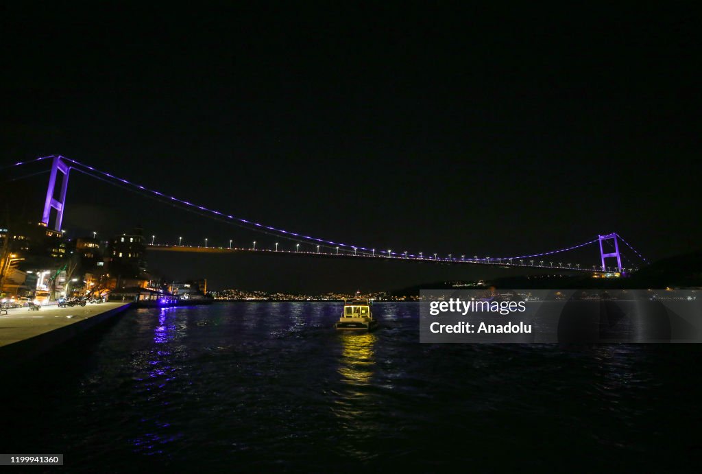 Fatih Sultan Mehmet Bridge is illuminated with purple...