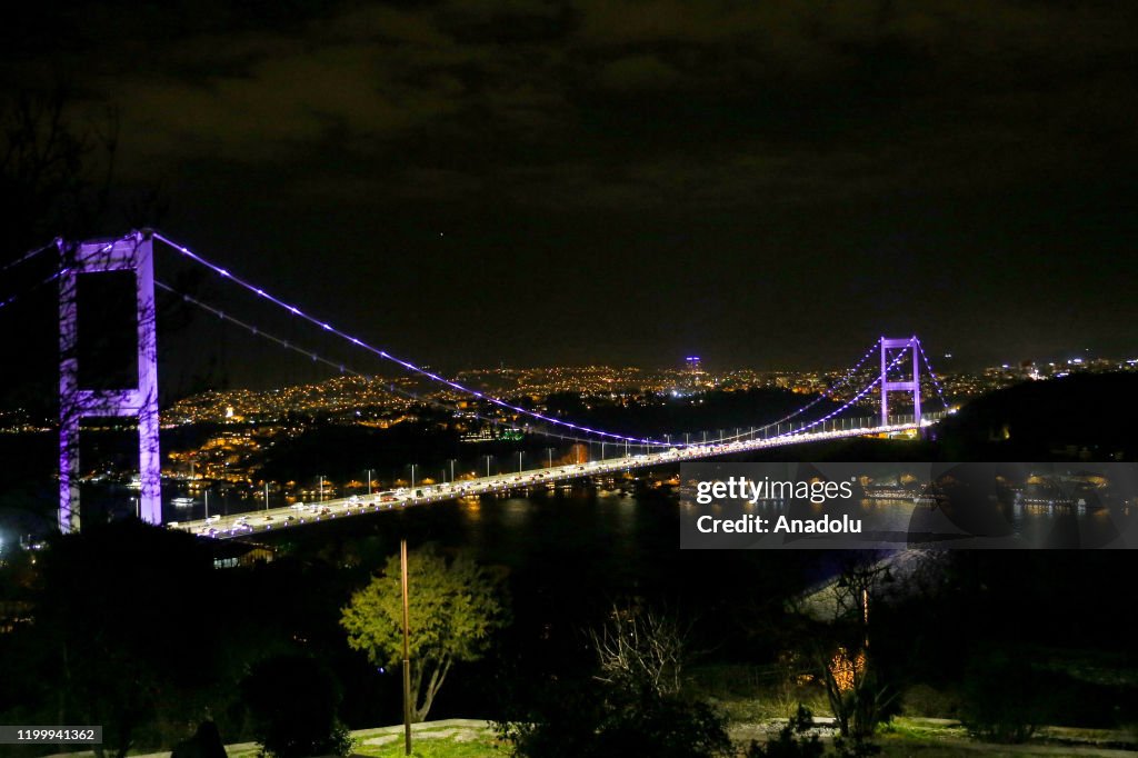 Fatih Sultan Mehmet Bridge is illuminated with purple...