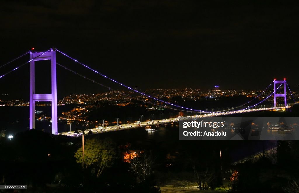 Fatih Sultan Mehmet Bridge is illuminated with purple...