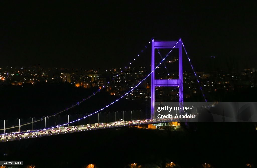 Fatih Sultan Mehmet Bridge is illuminated with purple...