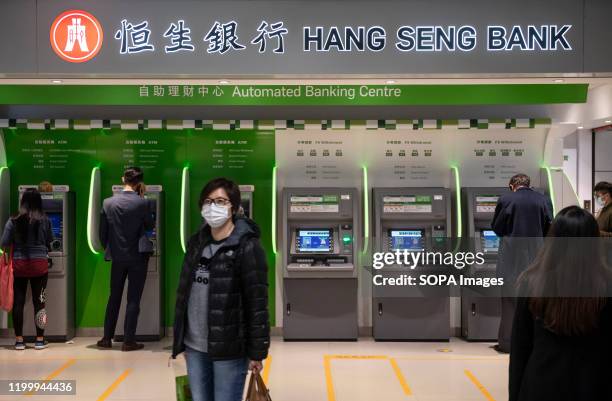 Commuters withdraw money from a Hang Seng Bank ATM in Central MTR subway in Hong Kong.