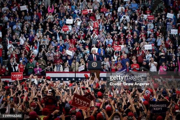 Supporters cheer as U.S. President Donald Trump arrives for a "Keep America Great" rally at Southern New Hampshire University Arena on February 10,...