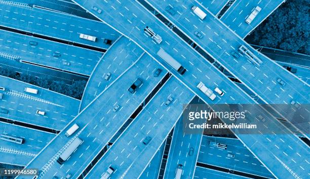 concept of mobility in the city with cars driving on several roads - transportation stock pictures, royalty-free photos & images