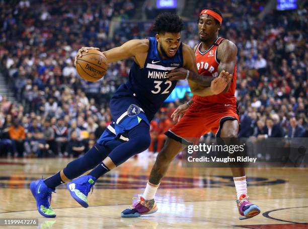 Karl-Anthony Towns of the Minnesota Timberwolves dribbles the ball as Rondae Hollis-Jefferson of the Toronto Raptors defends during the first half of...