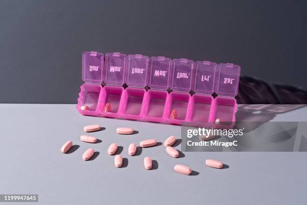 pills spilling form pill organizer - week stock-fotos und bilder