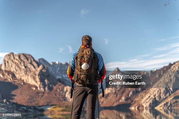 camino de santiago hiker with backpack and shell looking at the landscape - pilgrim stock pictures, royalty-free photos & images
