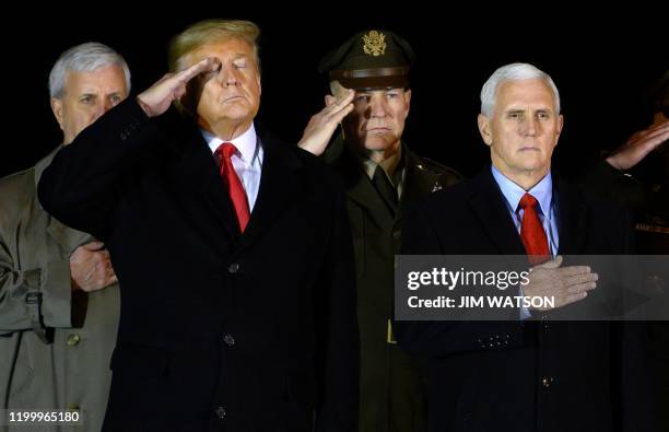 President Donald Trump and Vice President Mike Pence observe the dignified transfer of two US soldiers, killed in Afghanistan, at Dover Air Force...