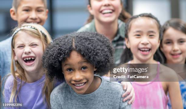 multi-ethnic group of elementary aged friends portrait stock photo - blonde hair roots stock pictures, royalty-free photos & images