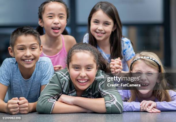 elementary students in a human pyramid stock photo - human pyramid stock pictures, royalty-free photos & images