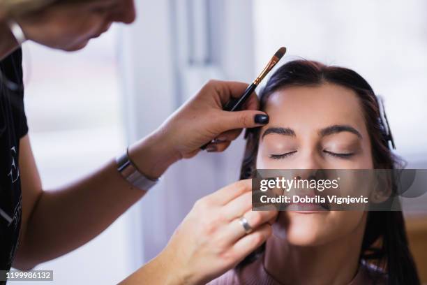 girl at makeup artist - makeup artist stock pictures, royalty-free photos & images