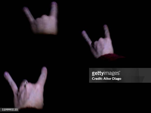 hands doing the rock sign reflected with a black background. - heavy metal horns stock pictures, royalty-free photos & images