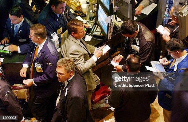 Traders work the floor of the New York Stock Exchange August 2, 2002 in New York City. Stocks fell again today after U.S. Employment data added to...