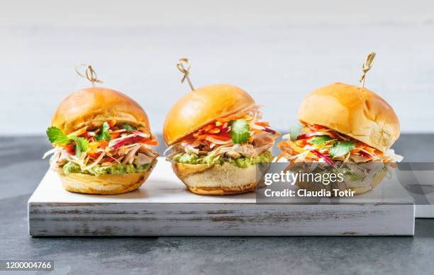 three sliders on a cutting board on white background - mini burger stock pictures, royalty-free photos & images