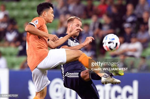 Chiangrai United's Piyaphon Phanitchakun tackles Melbourne Victory's Ola Toivonen during their AFC Champions League football match in Melbourne on...