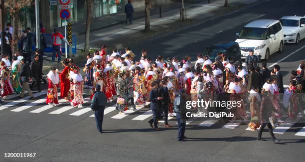 japanese new adults wearing kimonos and suits on 'coming of age day' on the street in yokohama - japan coming of age day 2019 stock pictures, royalty-free photos & images