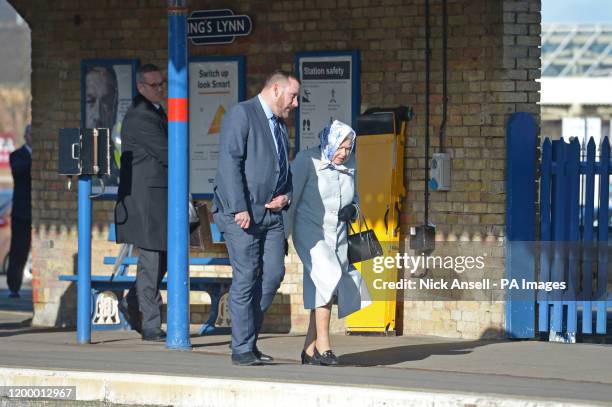 Queen Elizabeth II walks alongside station manager Graeme Pratt as she arrives at King's Lynn railway station in Norfolk, ahead of boarding a train...