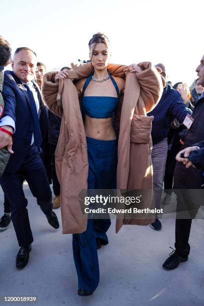 Bella Hadid wears a brown wool long coat, blue Vuitton bras, blue