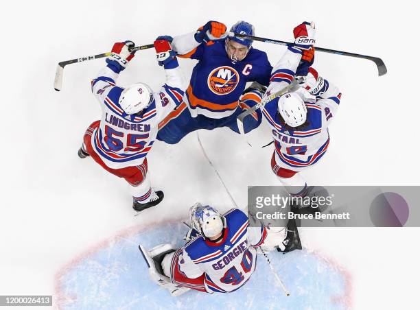 Ryan Lindgren and Marc Staal of the New York Rangers defend against Anders Lee of the New York Islanders during the third period at NYCB Live's...