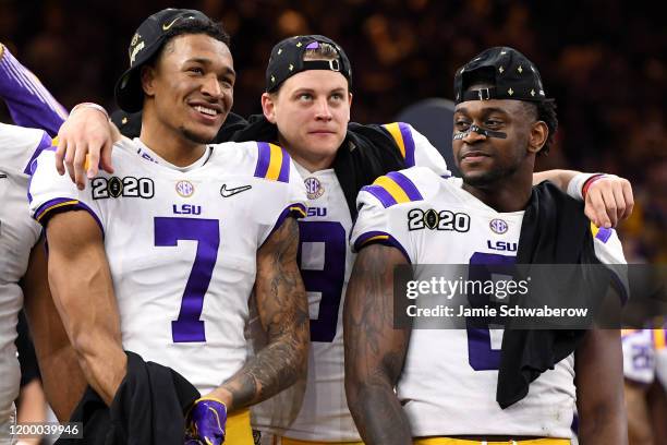 Grant Delpit, Joe Burrow and Patrick Queen of the LSU Tigers celebrate after defeating the Clemson Tigers during the College Football Playoff...