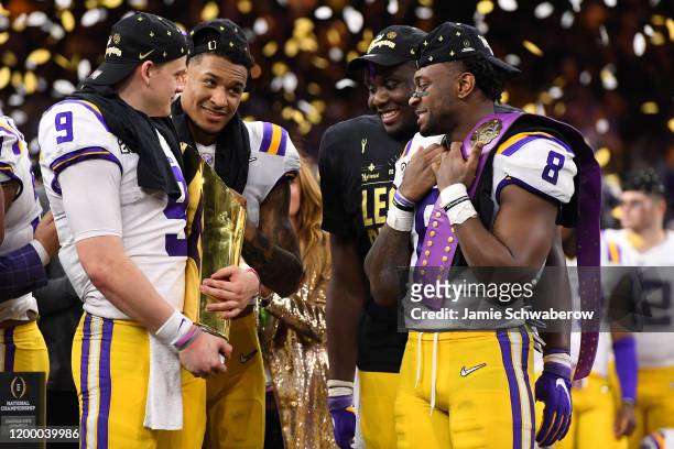 Grant Delpit, Joe Burrow, Lloyd Cushenberry III and Patrick Queen of the LSU Tigers celebrate after defeating the Clemson Tigers during the College...