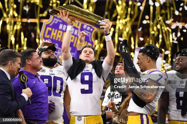 Joe Burrow of the LSU Tigers holds up the trophy after defeating the Clemson Tigers during the College Football Playoff National Championship held at...