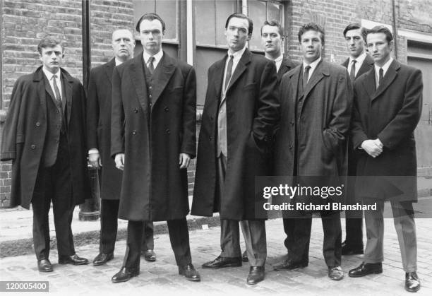 British gangsters Reggie Kray, played by Martin Kemp and Ronnie Kray, played by Gary Kemp , with members of their gang in 'The Krays', directed by...