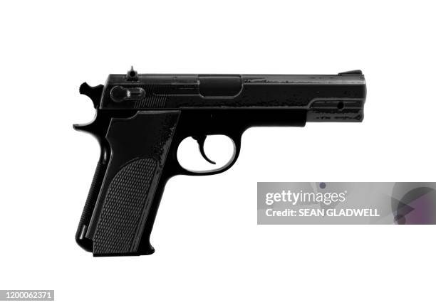 isolated black handgun - wapencontrole stockfoto's en -beelden