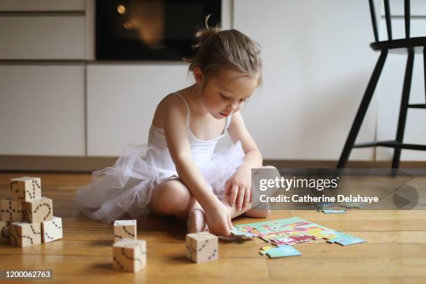 a 4 years old girl dressed as a dancer, playing in the kitchen - 4 5 years foto e immagini stock