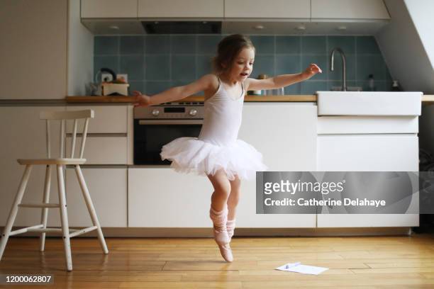 a 4 years old girl dressed as a dancer, dancing in the kitchen - ballerinas bildbanksfoton och bilder